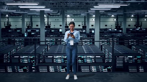 Full Body Of Asian Business Woman Using Mobile Phone In Data Center