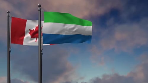 Waving Flags of Canada and Sierra Leone Against a Cloudy Sky