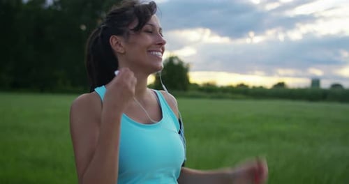 Woman Puts Earbuds in for Outdoor Run
