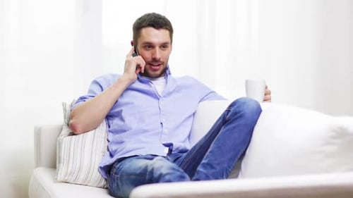 Man Chatting on Phone While Relaxing on Couch
