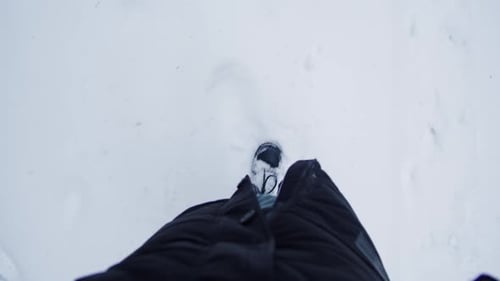 Man or Woman in Brown Winter Boots Walks Along a Snowy Road Closeup Follow in Winter Forest Park