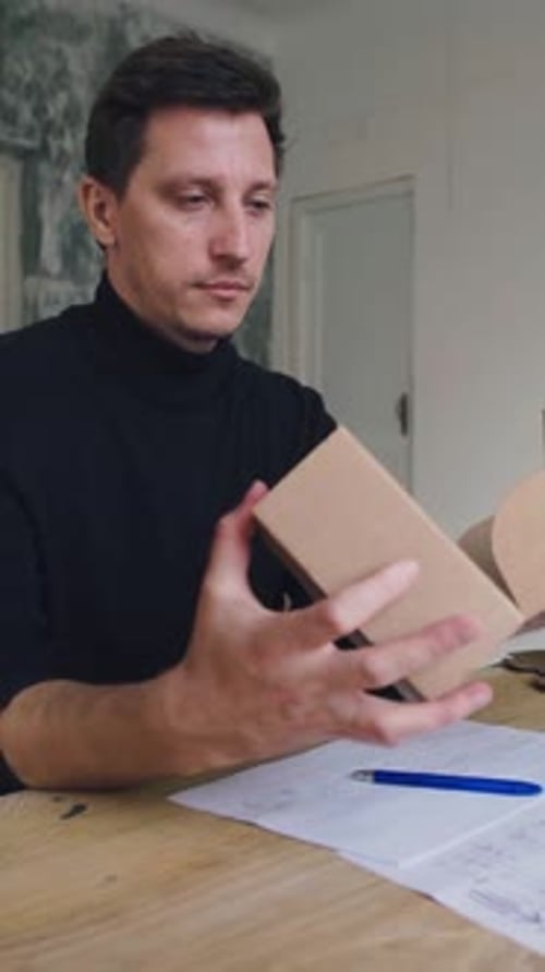 Designer Works Develops Packaging Design Using Computer and Drawing Young Attractive Caucasian Male