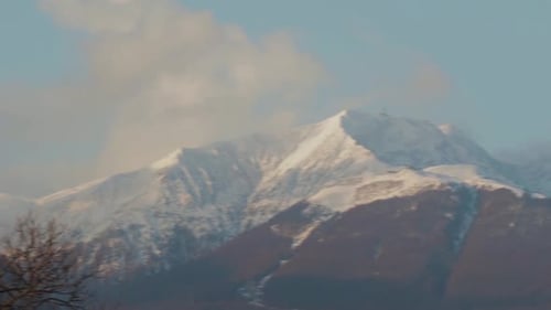 Fast Pan Across Snow Capped Alp Mountain