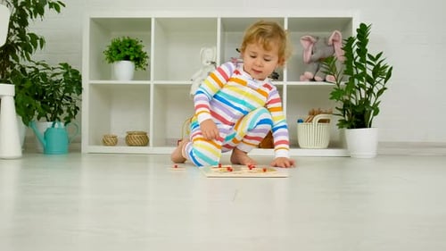 Little Child Playing with Puzzle on Floor