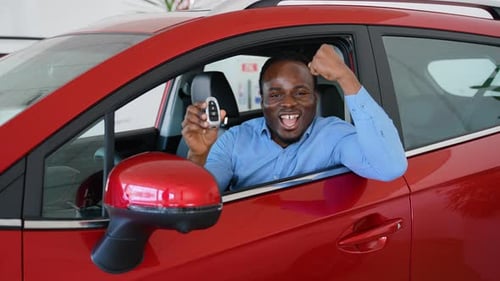 Yes That's My New Car Happy Customer Sitting in New Electric Car with Keys in Hand in Car Dealership