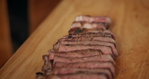 Close Up of Sliced Steak on Cutting Board