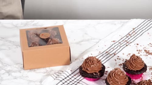 Packaging Chocolate Cupcakes with Chocolate Ganache Frosting Into a Paper Cupcake Box