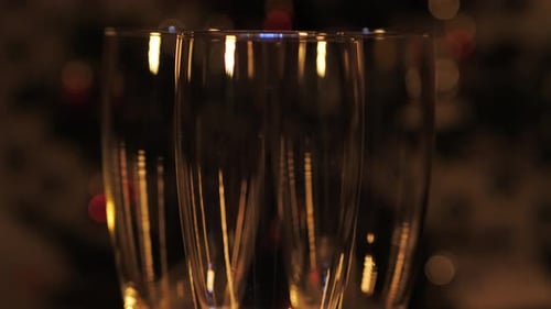 Bubbles sparkle in champagne glasses and spin slowly. Bubbles rise beautifully up in glasses. Blurre