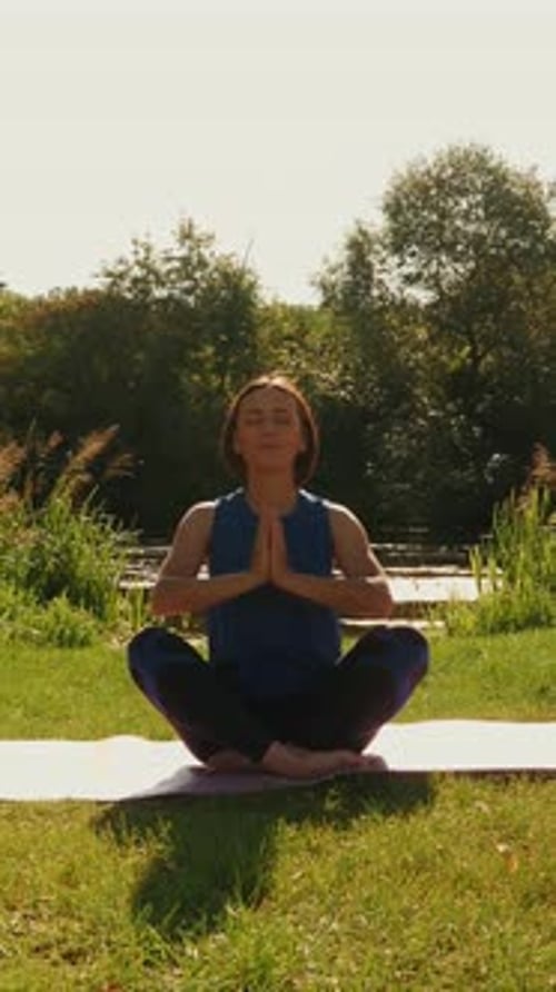 Woman Practicing Yoga Outdoors in Green Space