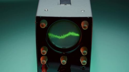 Oscilloscope with Control Knobs Showing Wavy Green Signal Pattern on Screen