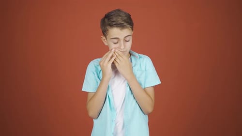 Sick boy coughing.