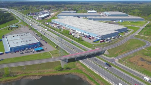 Aerial view of goods warehouse. Logistics center in industrial city zone from above. Aerial view of