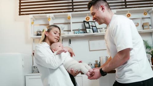 Loving Parents with Baby in Bright Home Kitchen