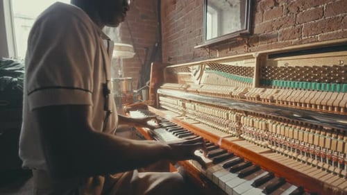 Young Black Musician Playing Piano in Classic Jazz Bar