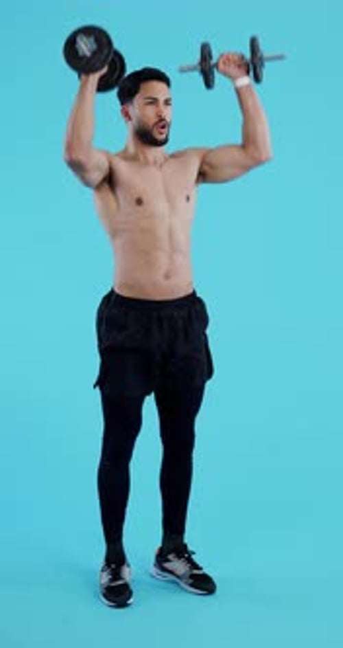 Man Working Out with Dumbbells on Blue Background