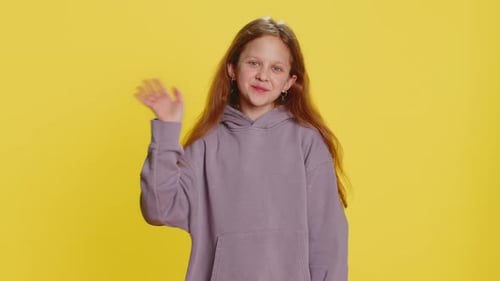 Young Cute School Girl Kid Smiling Friendly Gesturing Hello or Goodbye Welcoming Waving Hands
