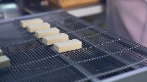 Delicious factory making deserts. Tasty sweet candies on conveyor.