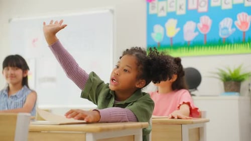 Group of student learn with teacher in classroom at elementary school.