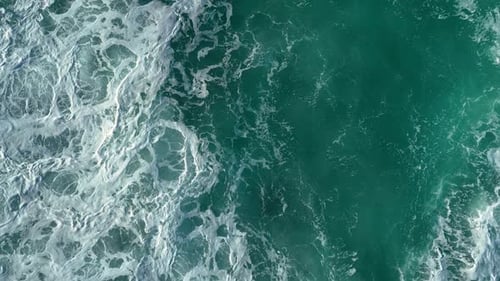 Above View Of Sea Waves With Splashes And Foam Crash Over The Shore. Aerial Drone Shot