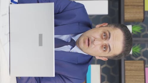 Professional Man Speaking Into Laptop Indoors