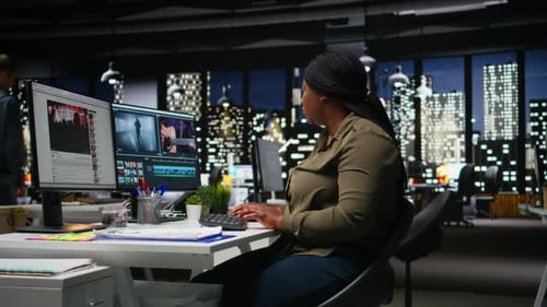 Portrait of Black Woman Video Editor Working with Dual Monitors in Agency