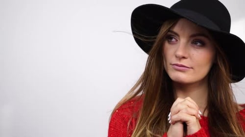 Woman in Black Hat with Hands Together