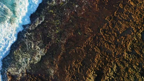 Soothing View of Ocean Waters Washing Volcanic Rocky Rough Beach