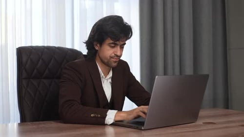 Man Types on Computer Before Showing Stress