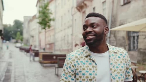 Likable Young African Man Walking Down the Street Looking at Sky Portrait of Happy Terrific Stylish