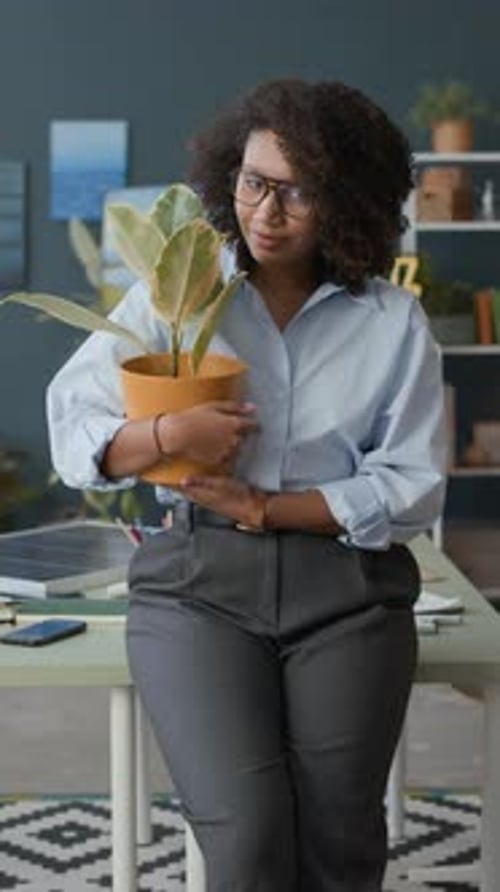 Portrait of African American Businesswoman with Potted Plant in Office