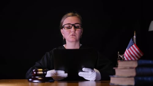 A Judge Reviews Legal Documents in a Courtroom Symbolizing Justice and Dedication to the Legal