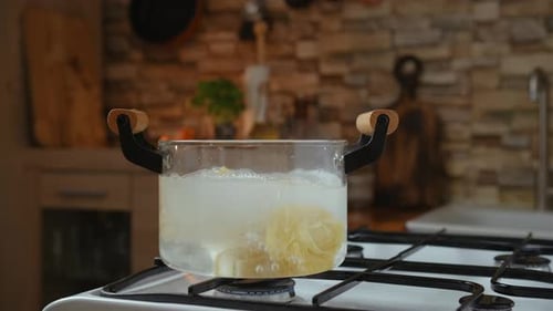 Adding Pasta to Boiling Water in Kitchen
