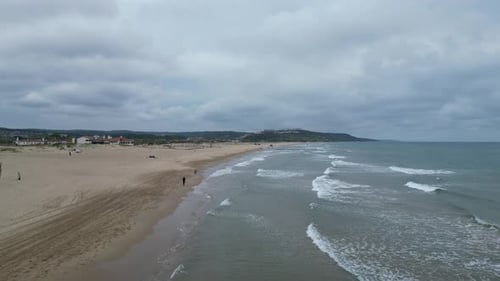 Flying over the junction of sand and sea on the beach