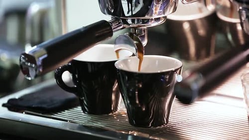 Espresso Machine Brewing Fresh Coffee Into Two Cups
