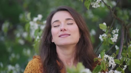 Natural Beauty of Charming Woman Female Portrait in Blooming Garden in Spring Day