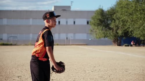 Young little league baseball pitcher throwing ball