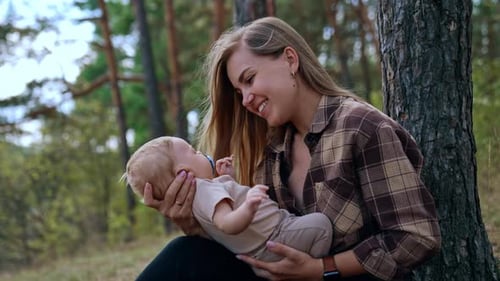 Mom communicating with her baby in nature.