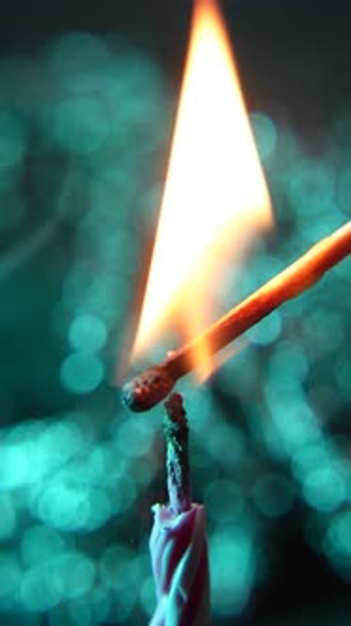 Close Up Lighting a Birthday Candle at Night