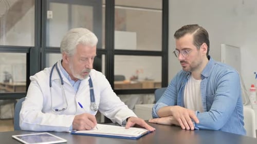 Doctor Consults Patient in Bright Medical Office