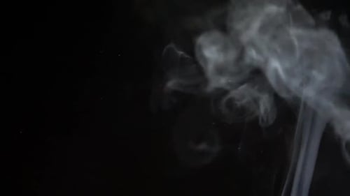 Wispy Plumes of White Smoke on Black