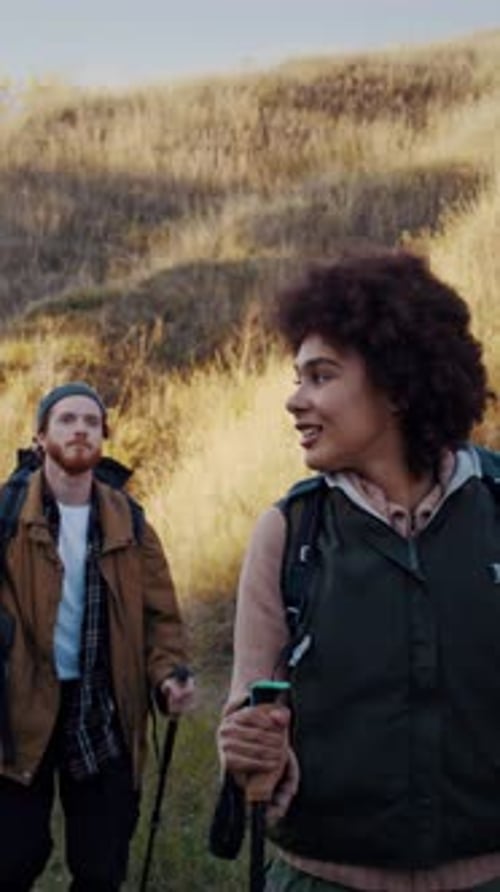 African American Woman with Boyfriend Walks in Valley with Hills