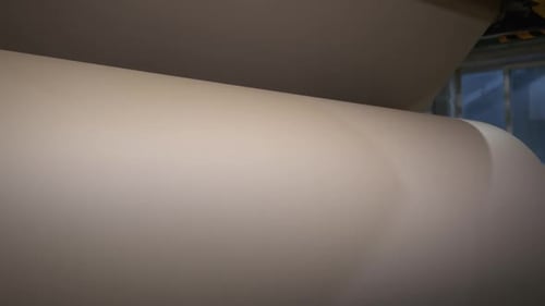 Unrolling Huge Roll with Brown Paper at Manufacturing Plant