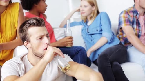 Friends Talking and Drinking Together at Home