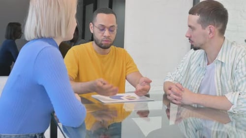 Team Discussing Data Charts in Modern Office