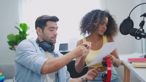 Diverse young stylish audio producer working in the music record studio.