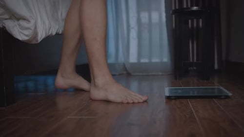 Bare Feet Stepping on a Digital Scale at Home