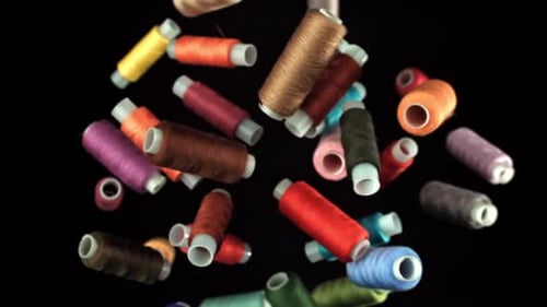 Multicolored Threads Fly on a Black Background Filmed on a Highspeed Camera at 1000 Fps