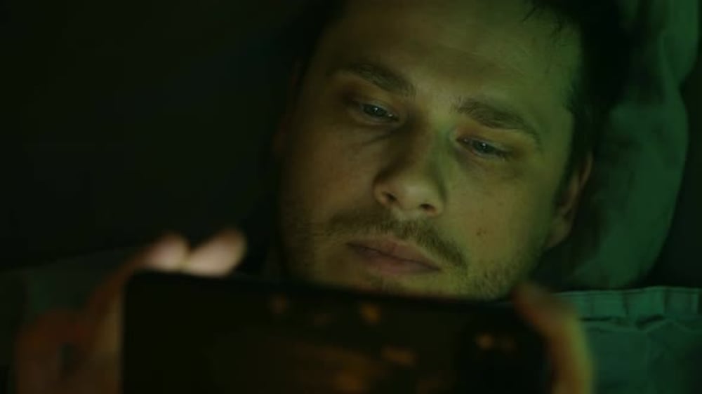 In Green Dim Light of His Room Young Man Indulges in Smartphone Diving ...