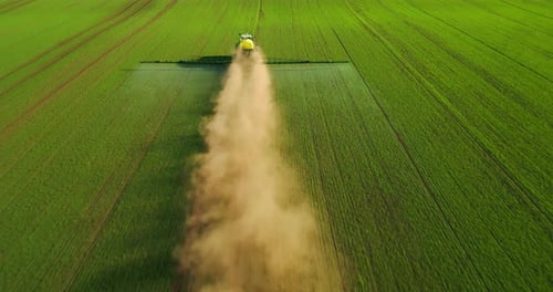 Aerial View of Farming Tractor Spraying on Field