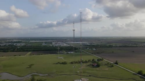 Aerial Shot Floating Towards Two Tall Cellular Towers In American Farmland